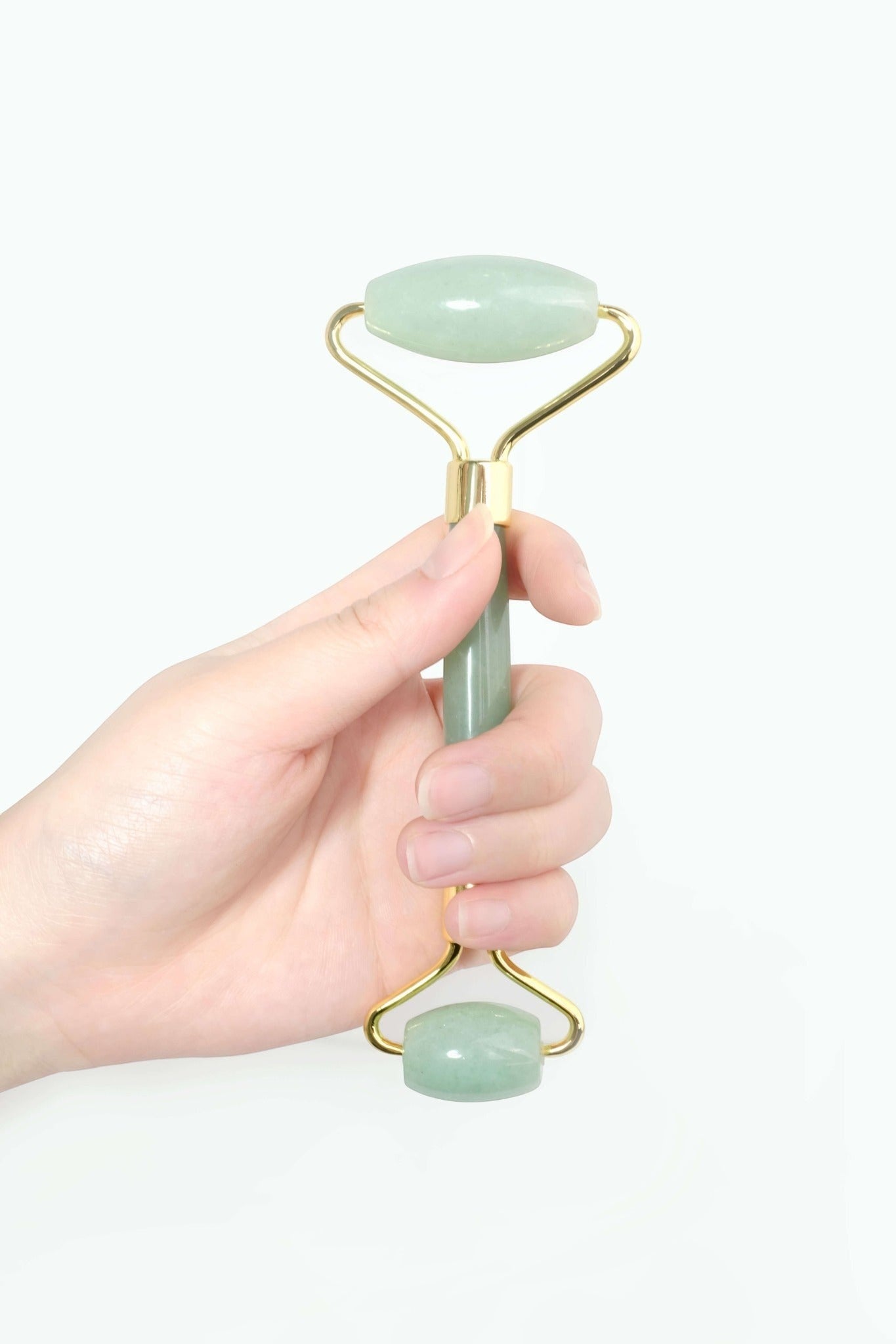 CatMoz jade facial roller with gold accents, featuring a light green stone and dual rollers for face and body.